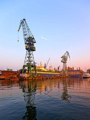 Wall Mural -  View of the industrial zone. Cranes, docks in shipyard.