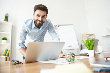 Sticker - Cheerful man is using a notebook for work