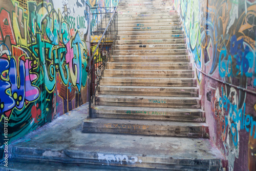 Houses covered under colorful graffiti in Valparaiso, Chile
