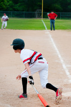 Youth Baseball Hitter Sitting Bat Down.
