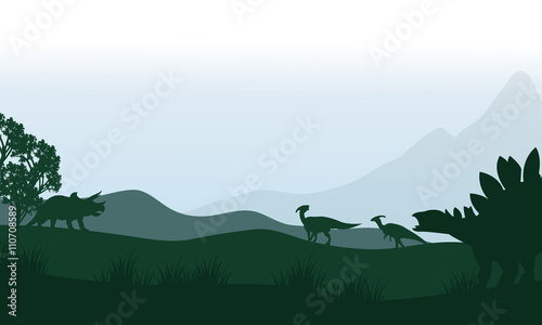 Fotografía Silhouette of stegosaurus and parasaurolophus in fields