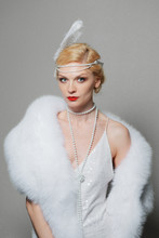 Woman In White Dress With Shoulder Straps And Long Fur Stole