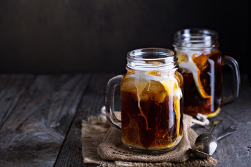 Wall Mural - Iced coffee with milk in mason jars