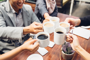 business Friends Cheering With Coffee at cafe