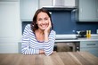 © WavebreakMediaMicro - Cheerful young woman sitting at table