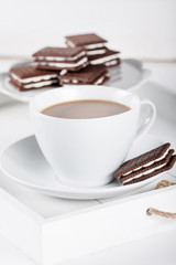 Wall Mural - Cup of coffee and plate with cookies on a white tray