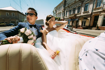 Wall Mural - Stylish couple in the car on the street