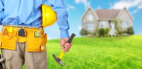 Wall Mural - Construction worker with helmet and hammer.