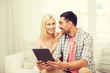 © Syda Productions - smiling happy couple with tablet pc at home