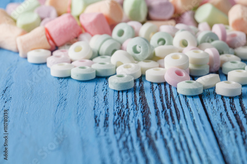 Obraz Dibond Candy on a blue pastel colored background
