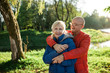 © goami - happy seniors couple embrace and smile;