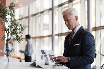 Wall Mural - senior business man reading magazine