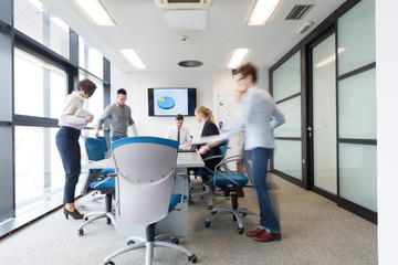 Wall Mural - business people group entering meeting room, motion blur