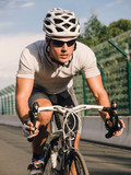 Fototapeta  - Cyclist pedaling on a racing bike outdoor