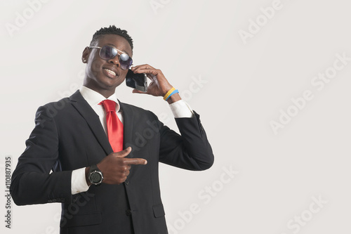 Young african American man using a mobile phone Poster