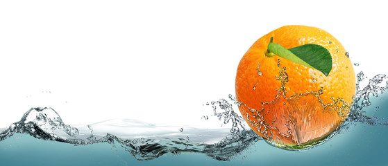 The fruit of a ripe tangerine on a background of splashing water.