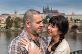 Fototapeta Paryż - happy couple embracing in the background Charles Bridge in Prague