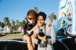© Connect Images - Young couple outdoors, looking at instant film photograph