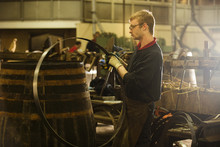 Male Cooper Making Whisky Casks In Cooperage