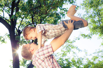 Canvas Print - Father and son playing at the park at the day time.