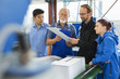 © Connect Images - Factory workers with supervisor