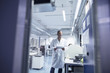 © Connect Images - Lab assistant checking details on digital tablet