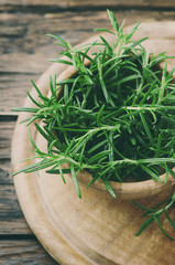 Wall Mural - Aromatic fresh rosemary on the wooden table