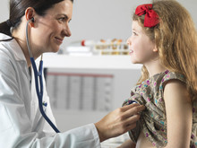 Doctor Bonding With Young Girl During Consultation