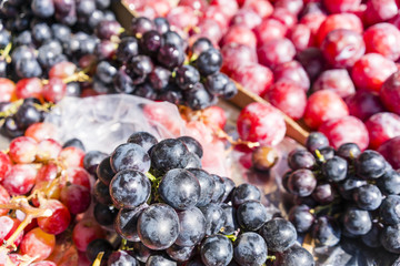 Red and black grapes in a market in Paris, France