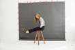 © Connect Images - Woman on stool in front of photographers backdrop