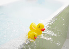 Rubber Ducks Falling Out Of Bath Overflowing With Water