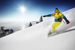 Snowboarder rides over fresh powder on the slope. Sheregesh resort, Siberia, Russia