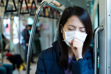 Wall Mural - Woman wearing face mask in train compartment