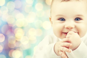 happy baby over blue holidays lights background