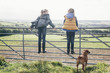 © Connect Images - Two girls standing on metal gate