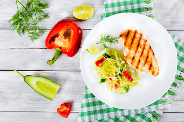 Canvas Print - grilled chicken breast fillet with vegetables salad, top view