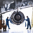 © Connect Images - Engineers working on aircraft engine in aircraft maintenance factory