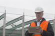 © Connect Images - Dock worker using digital tablet at port