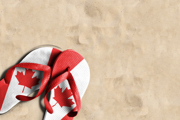 Wall Mural - Thongs with flag of Canada, on beach sand