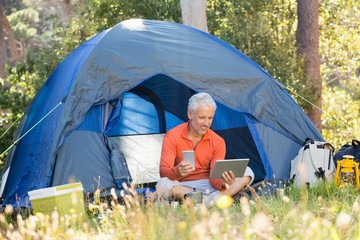 Poster - Mature man using tablet and phone