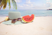 Summer Vacation Concept Straw Hat With Sunglasses And Melon Fruit On Sandy Tropical Beach