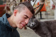 © Matteo Viviani - Friends at first sight, young man befriending a cat, color version