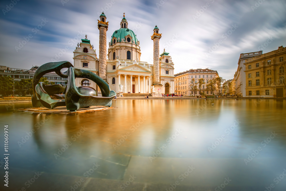 View on st. Charles's church on Karlsplatz in Vienna. Long exposure technic with blurred clouds and glossy water - obrazy, fototapety, plakaty 