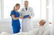 © Syda Productions - doctor and nurse visiting senior woman at hospital