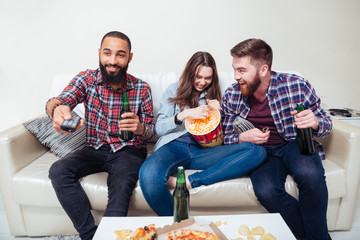 Wall Mural - Friends watching tv at home and laughing