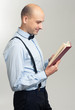 © spaxiax - stylish bald man reading a book