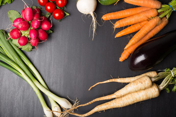 Fresh Vegetables on Black Stone surface background with empty space  