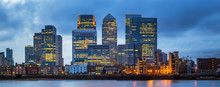 London, United Kingdom - Panoramic View Of Canary Wharf, The Famous Business District With Illuminated Skyscrapers Of London At Blue Hour