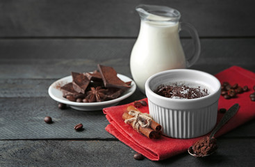 Wall Mural - Chocolate fondant cake in cup on wooden background