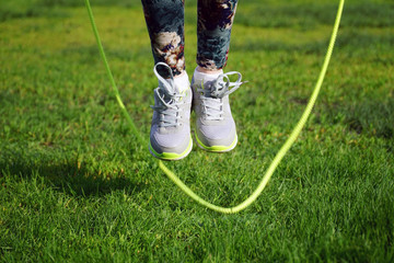  woman jumping on a skipping rope in park 